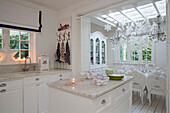 Marble topped kitchen island with view to extended dining room at Christmas in South London family home England UK