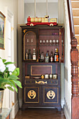 Vintage toy train on wooden drinks cabinet in Gloucestershire home England UK