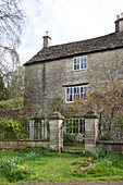 Detached stone facade of Gloucestershire farmhouse England UK