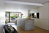 Polished concrete kitchen island in split-level open plan London townhouse England UK