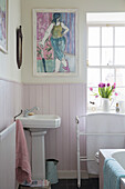 Pedestal basin under modern artwork in tongue and groove cottage bathroom Midlothian Scotland UK