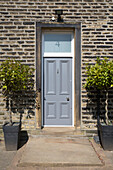 Light grey front door of Victorian semi-detached villa built in 1875 Brighouse West Yorkshire UK