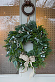 Christmas wreath and door knocker on front door of Cheshire home UK