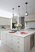 Pendant shades above kitchen island in London townhouse UK