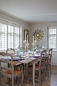 Painted chairs at dining table in West Sussex home