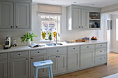 Bar stool at sink in fitted West Sussex kitchen window