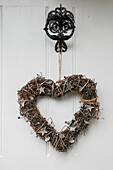 Heart shaped Christmas wreath on front door of Grade 11 listed farmhouse on Wiltshire Dorset borders UK