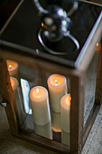 Lit candles in hurricane lamp Dorset farmhouse UK
