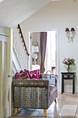 Bag on sofa in hallway of detached Sussex country house UK