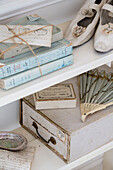 Vintage shoes with fan and books tied with string in Edwardian house Surrey UK