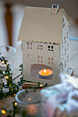 Lit tealight in model house West Sussex farmhouse UK