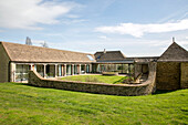 Stone wall around garden of Gloucestershire barn conversion UK