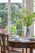 Blattarrangement auf einem hölzernen Esstisch am Fenster in einer denkmalgeschützten Villa (Grade II) in Arundel, West Sussex, Großbritannien