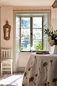 Quilted tablecloth at sunlit window in Somerset home UK