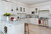 Wooden bar stool at kitchen bar in tiled Hampshire kitchen UK