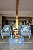Pair of light blue armchairs and metal trunk in extension of Grade II listed Hampshire cottage built c1500