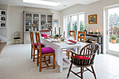 Dining table and chairs in stone floored extension of East Dulwich Edwardian home London UK
