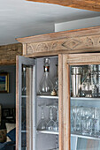 Decanter and glasses in wooden cabinet Oxfordshire home UK