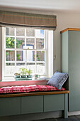 Window seat with light green storage in Kent cottage UK