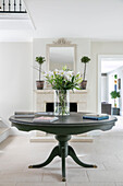 Lilies on grey pedestal table in entrance hall of Sussex home UK