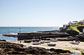 Fishing boats in coastal harbour Cornwall UK