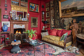 Collection of art with tapestry wall hanging and leopard skin rug in Sussex living room