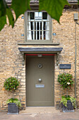 Front door of old firestation - an 1840s end of terrace Cotswold cottage in Oxfordshire UK