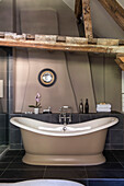 Slate floor with quartz stone bath and walls in Mouse?s Back Wiltshire cottage UK