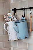 Whisk and spoons with enamel irrigator jugs in Derbyshire kitchen UK