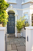 Paved exterior with grey paintwork on front door of London home UK