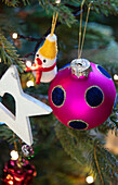 Pink bauble and snowman baubles in Christmas tree Surrey UK