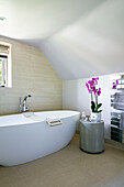 Freestanding bath and pink orchid Surrey UK