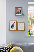 Framed artwork on picture shelves in Sussex home UK