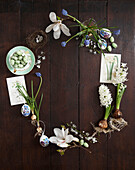Easter Egg shaped floral still life with Magnolia blossom muscari and hyacinths and easter eggs and nests