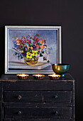 Dark Vintage cupboard and wall with Vintage floral artwork and tealights