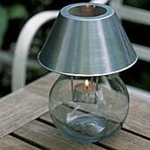 Garden lamp with candle on table