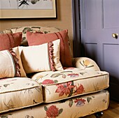 Upholstered floral sofa with cushions in a living room