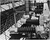 Inspector checking oil circuit breakers at a factory, London