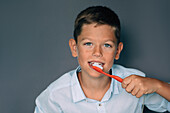 Young boy brushing his teeth