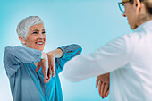 Doctor checking a senior woman for carpal tunnel syndrome