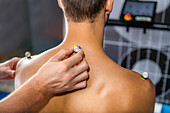 Placing markers on man's back for 3D gait analysis