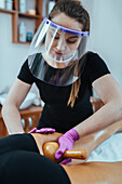 Madero massage therapist wearing PPE