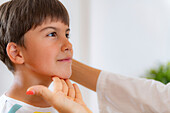 Boy undergoing a physical medical exam with therapist