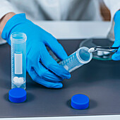 Scientist inserting pills into tubes
