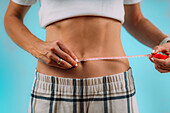 Woman measuring waist