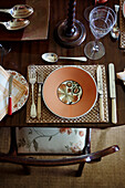 Festive place setting with silver cutlery on antique wooden table