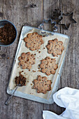 Baked biscuits on baking tray with cookie cutters and leftover dough