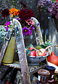 Autumn decoration with flowers and fruit on an old wooden ladder