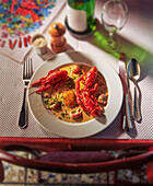 Crayfish with a fried egg on a laid table