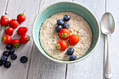 Porridge with strawberries and blueberries
